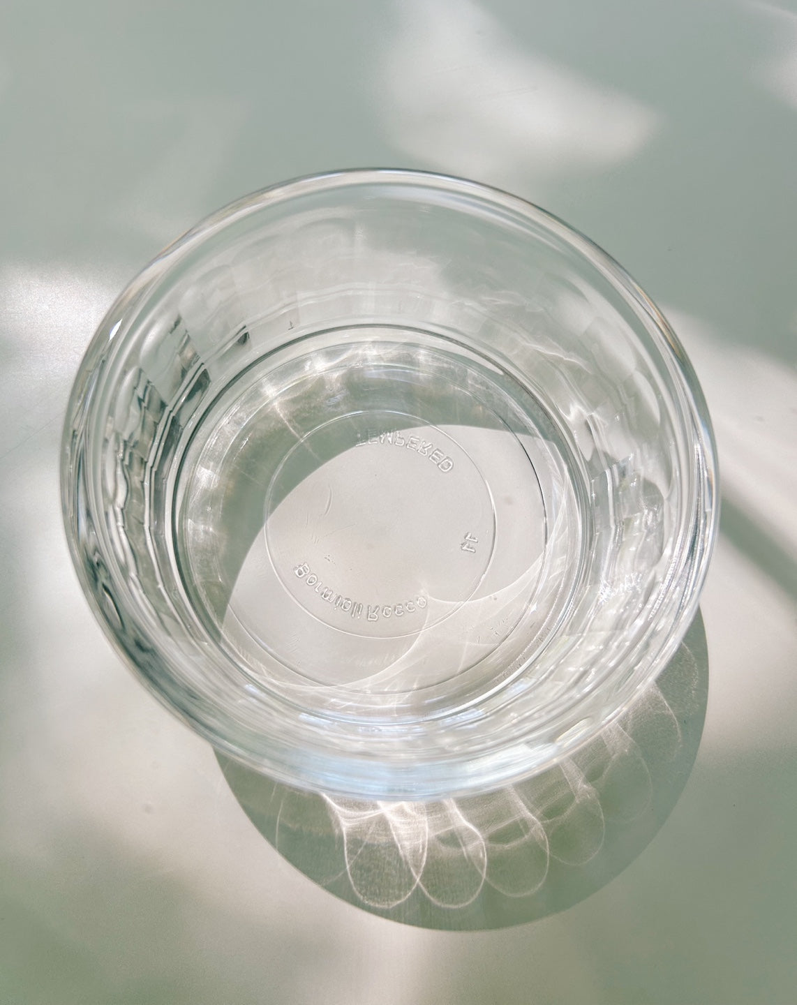Clear glass bowl on a reflective surface