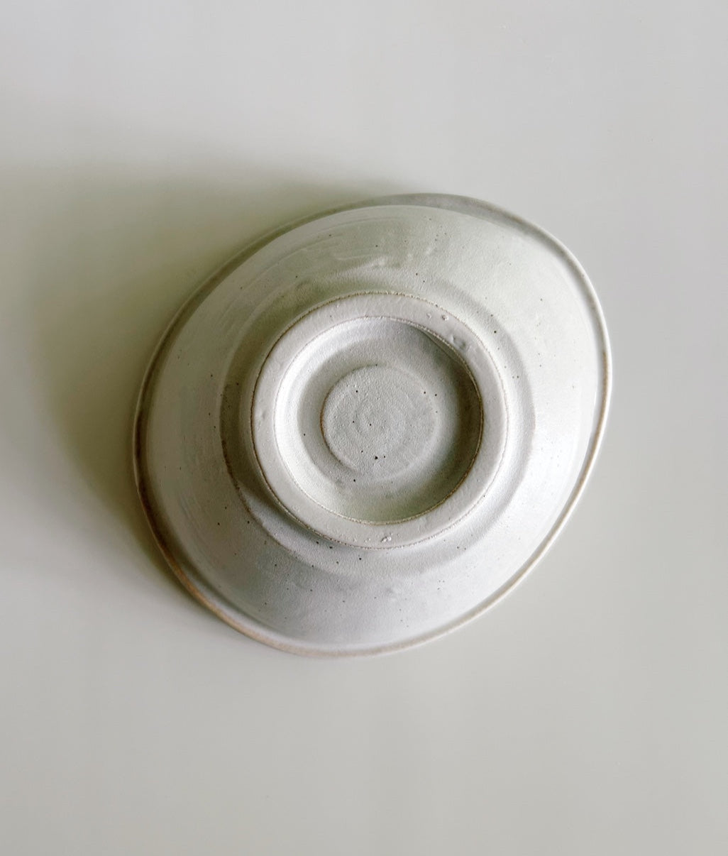 White ceramic bowl on a light gray background