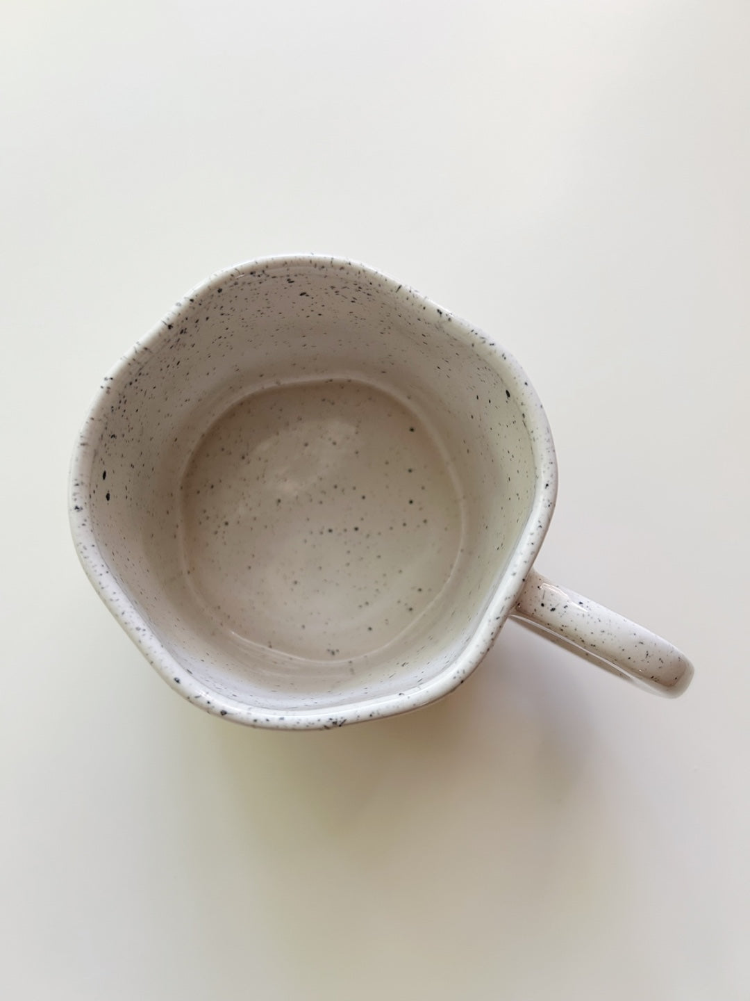 Speckled ceramic mug on a white background