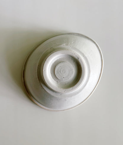 White ceramic bowl on a light gray background
